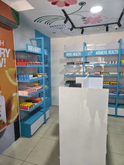 Pharmacy interior with shelves labeled 'Hair & Beauty', 'Men's Health', and 'Women's Health'.