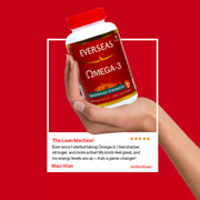 Hand holding a bottle of Everseas Omega-3 supplement with a red background