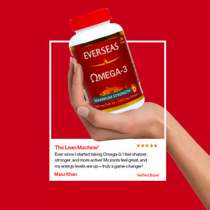 Hand holding a bottle of Everseas Omega-3 supplement with a red background