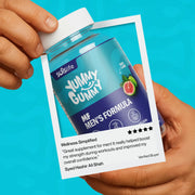 Hand holding a supplement container labeled 'Yummy Gummy' with a blue background